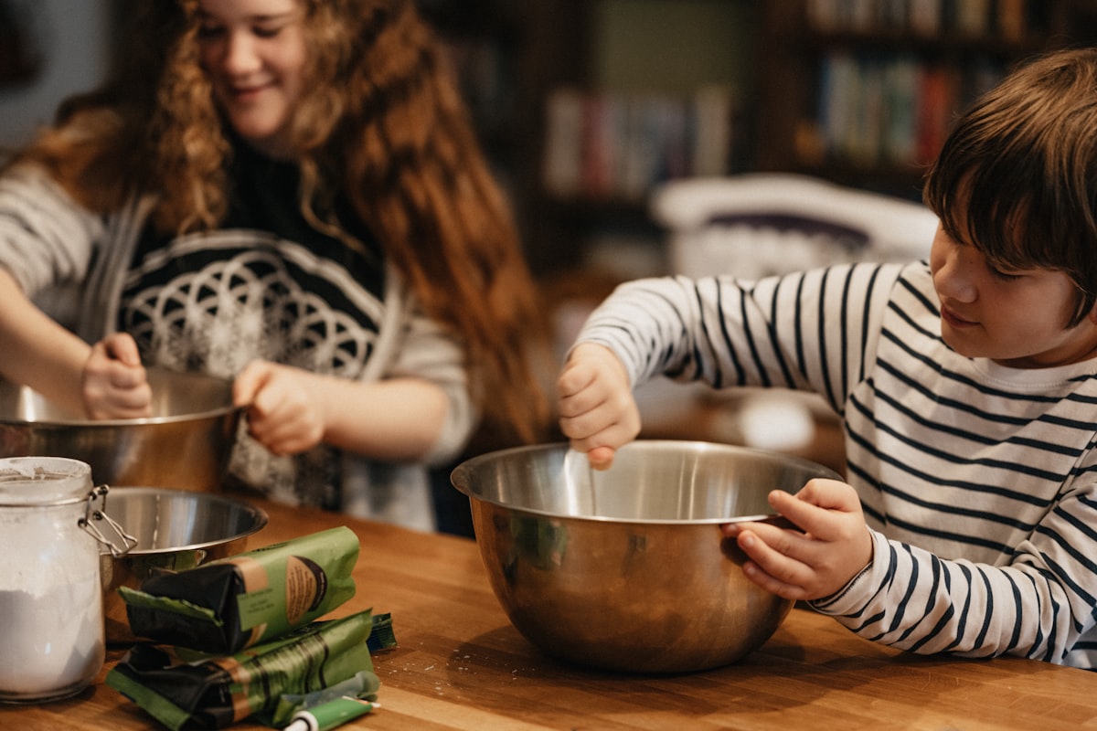 A parent and toddler cooking together in a bright kitchen as a screen-free weekend activity